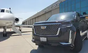 Private jet at an FBO with SUV staged