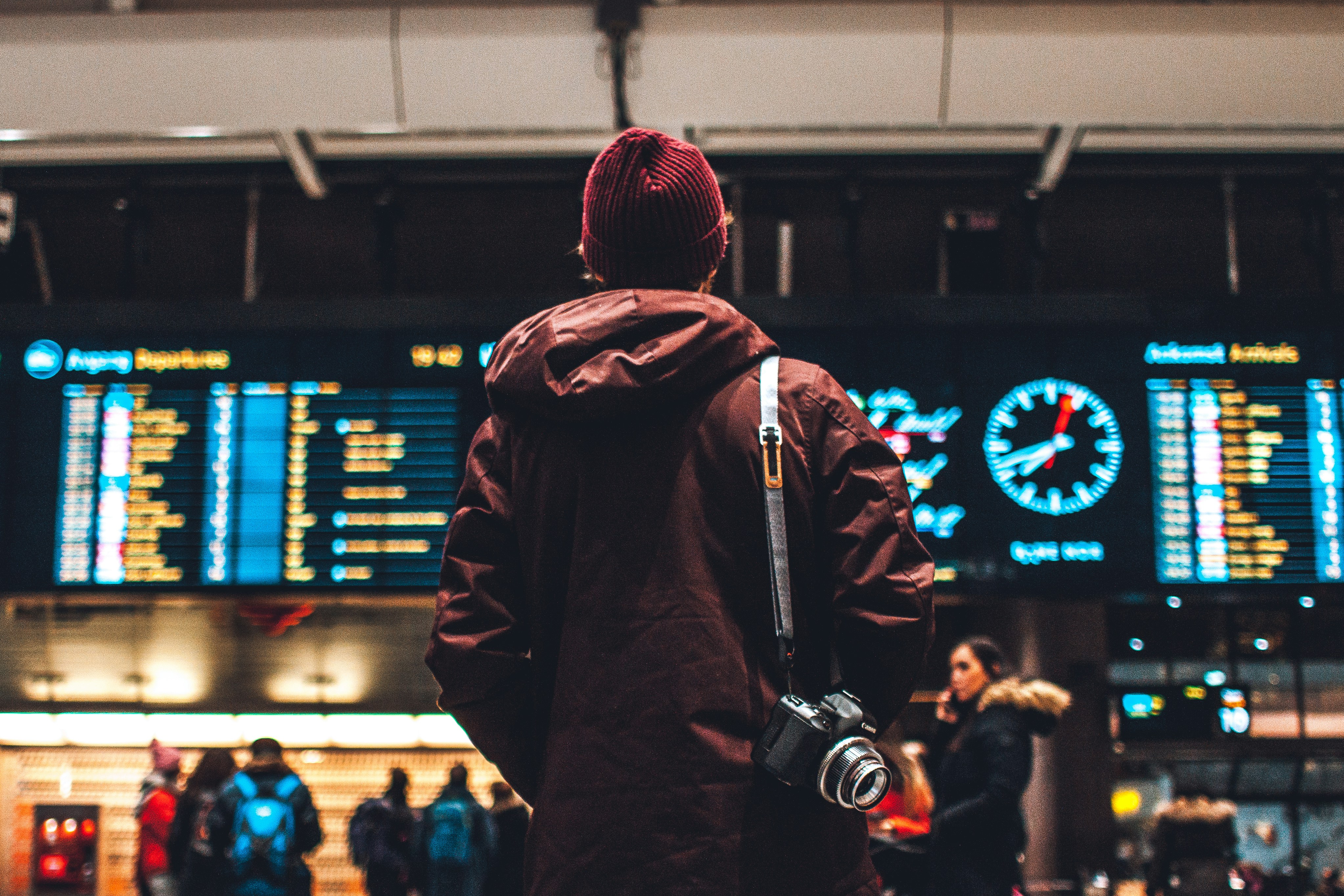 Young man looking at airport departures